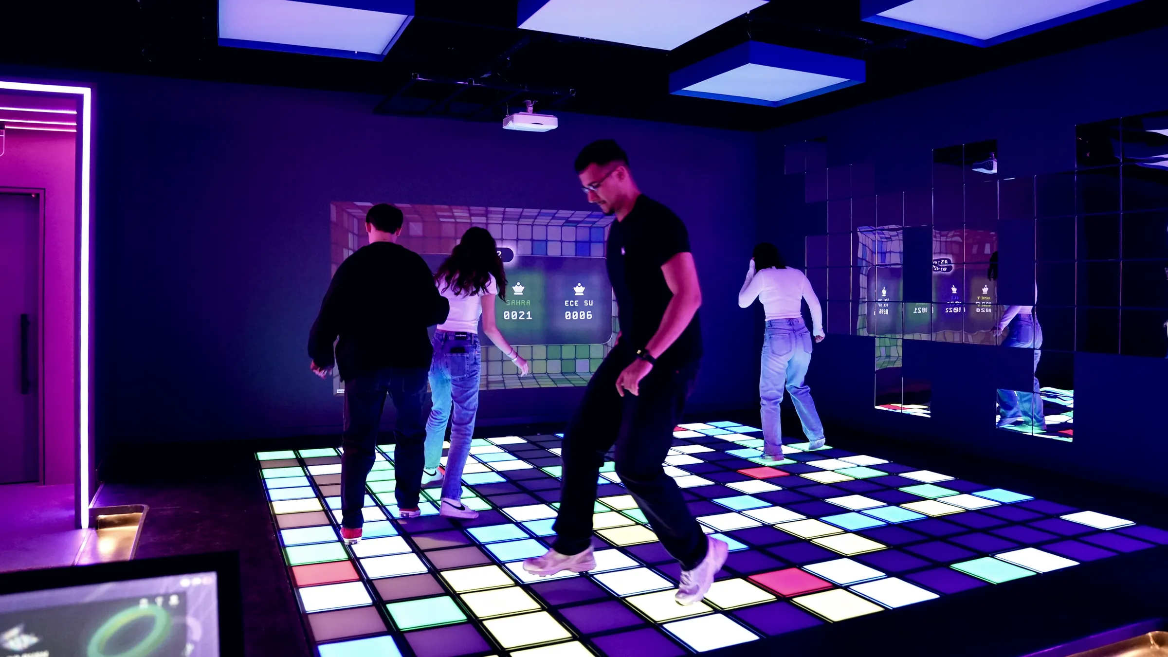 A group playing together on an illuminated interactive floor